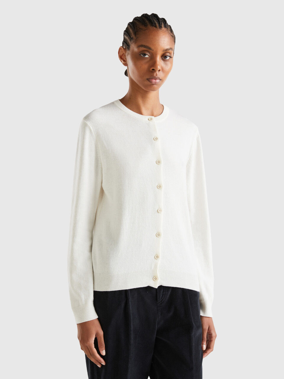 White cardigan with store buttons