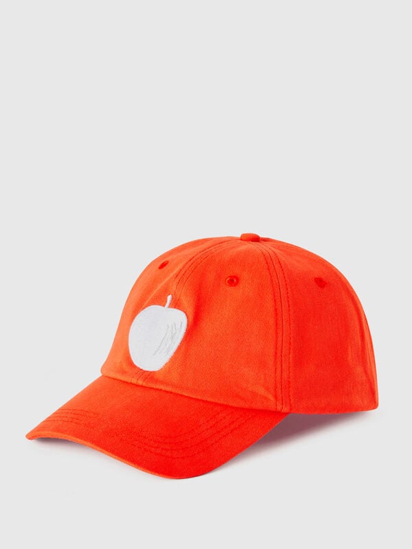 Orange cap with embroidered apple